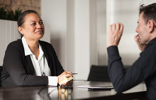Two different ethnicity People Holding a meeting using te reo maori.