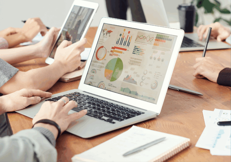 A group of people using laptops to make graphs